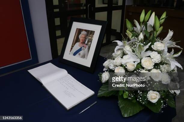 Portrait photographs of the late Queen Elizabeth II and a condolence book is kept at the British Deputy High Commission for the public to write their...