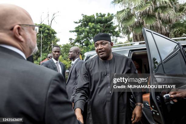 The president of The Gambia, Adama Barrow, greets the British High Commissioner to the Gambia, David Belgrove, as he arrives at the at the British...