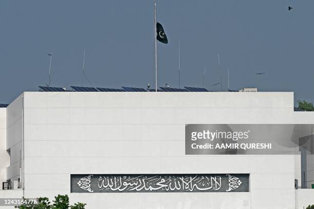 Pakistan's national flag flies half-mast at the country's Parliament House to mourn the death of Queen Elizabeth II, in Islamabad on September 12,...