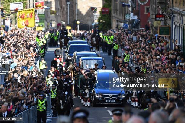 Members of the public gather to watch the procession of Queen Elizabeth II's coffin, from the Palace of Holyroodhouse to St Giles Cathedral, on the...