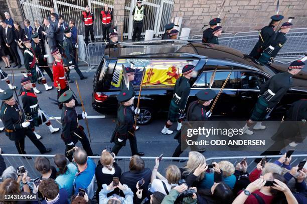 Members of the public gather to watch the procession of Queen Elizabeth II's coffin, from the Palace of Holyroodhouse to St Giles Cathedral, on the...