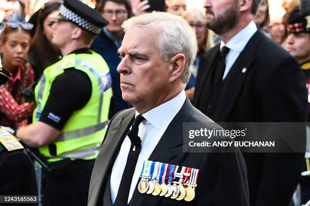Britain's Prince Andrew, Duke of York walks behind the procession of Queen Elizabeth II's coffin, from the Palace of Holyroodhouse to St Giles...