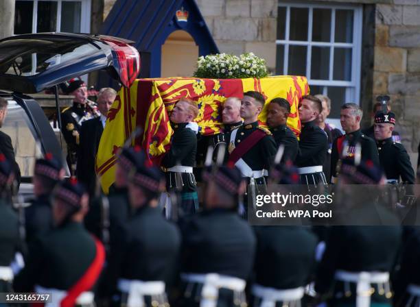 Royal guards carry Queen Elizabeth II's coffin at the start of the procession from the Palace of Holyroodhouse to St Giles' Cathedral on September...