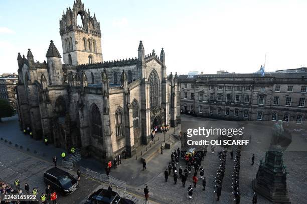 The hearse carrying the coffin of Queen Elizabeth II, from the Palace of Holyroodhouse, arrives at St Giles Cathedral, on the Royal Mile on September...