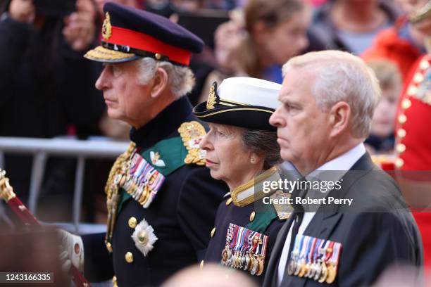 King Charles III, Princess Anne, Princess Royal and Prince Andrew, Duke of York walk behind Queen Elizabeth II's Coffin as it heads to St Giles...