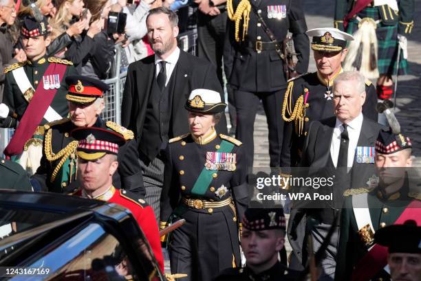 Britain's King Charles III, Britain's Princess Anne, Princess Royal, Britain's Prince Andrew, Duke of York and Vice Admiral Timothy Laurence walk...