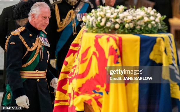 Britain's King Charles III walks past the coffin of his late mother, Queen Elizabeth II, inside St Giles Cathedral in Edinburgh on September 12...