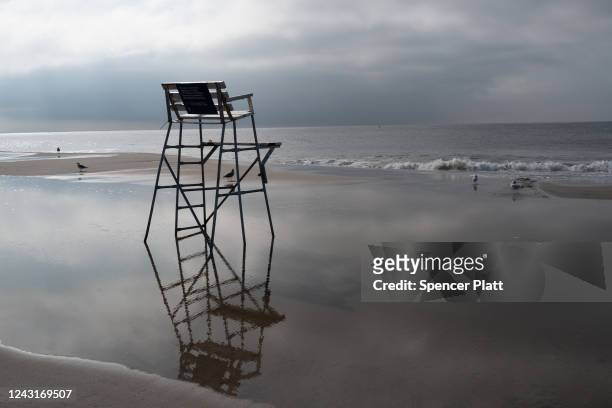 An empty lifeguard chair stands near a stretch of beach at Coney Island which is now a crime scene after a mother is suspected of drowning her...