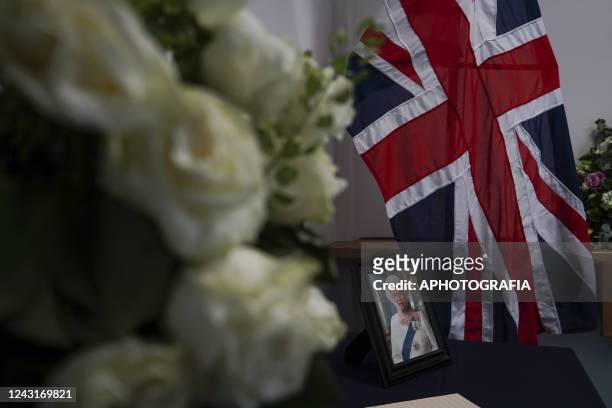 Portrait of Queen Elizabeth II next to a condolences book set for Salvadorans to sign at the British Embassy in El Salvador on September 12, 2022 in...