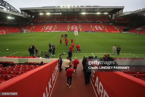 Ajax' players enter the pitch during an open team training session at the Anfield Stadium in Liverpool, north-west England, on September 12 on the...