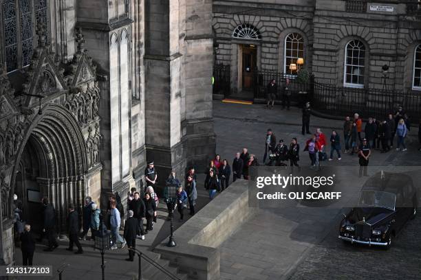 Members of the public queue to enter St Giles' Cathedral, in Edinburgh, on September 12 to pay their respects before the coffin of Queen Elizabeth II...