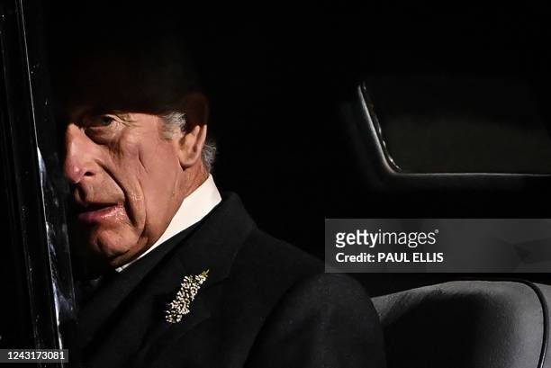 Britain's King Charles III reacts as he leaves at the end of a Vigil at St Giles' Cathedral, in Edinburgh, on September 12 following the death of...