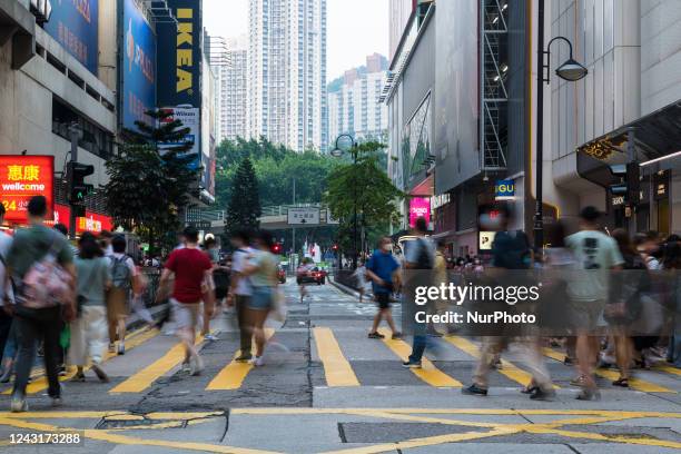 Hong Kong, China, 12 Sept 2022, People cross a street in Causeway Bay.