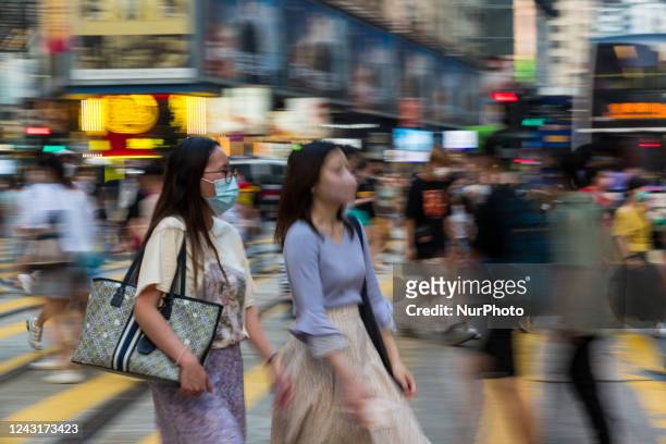 Hong Kong, China, 12 Sept 2022, People cross a street in Causeway Bay.