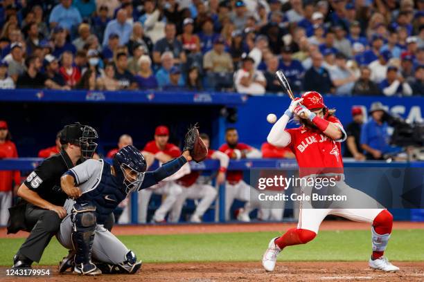 Bo Bichette of the Toronto Blue Jays avoids a high pitch in the sixth inning against catcher Francisco Mejia of the Tampa Bay Rays at Rogers Centre...