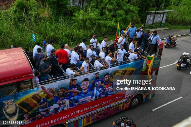 Members of the Sri Lankan cricket team travel on an open-top bus to celebrate their victory during the Asia Cup Twenty20 tournament in Dubai, after...