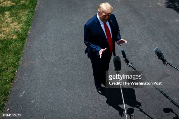 President Donald J. Trump speaks to reporters as he walks from the Oval Office to board marine One and depart from the South Lawn at the White House...