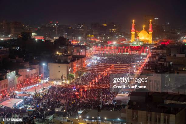 Shi'ite pilgrims walk along a street to the holy shrine of Hazrat Abalfazl Al- Abbas during the commemoration of Arbain in the holy city of Karbala,...