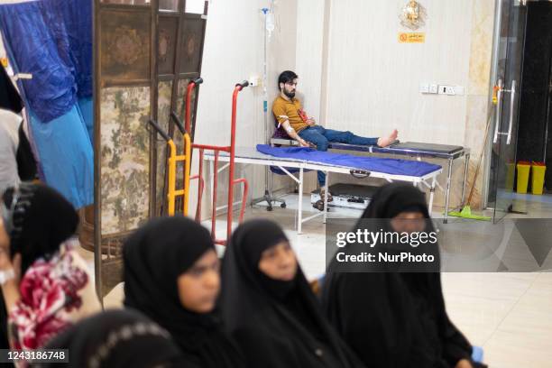 While commemorating Arbain in the holy city of Karbala, a Shi'ite pilgrim lies on a hospital mobile bed receiving medical care at a medical center...