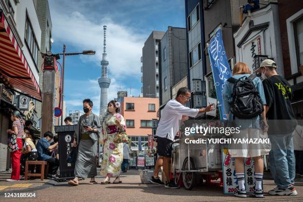 People visit the Asakusa area, a popular tourist location, in Tokyo on September 13, 2022.