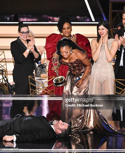 Jimmy Kimmel lies onstage as Quinta Brunson accepts the award for Outstanding Writing For A Comedy Series at the 74th Primetime Emmy Awards held at...