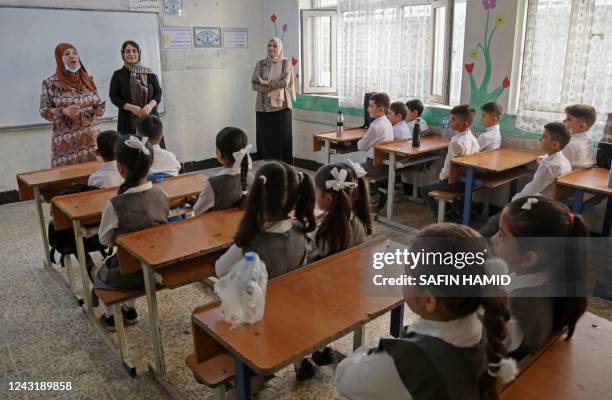 Pupils attend the first day of the new academic year in Arbil, the capital of northern Iraq's Kurdistan autonomous region, on September 13, 2022.