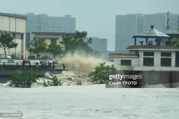 Citizen tourists watch the high tide of the Qiantang River at the Hangzhou section of the Qiantang River in Hangzhou, Zhejiang Province, China, Sept...