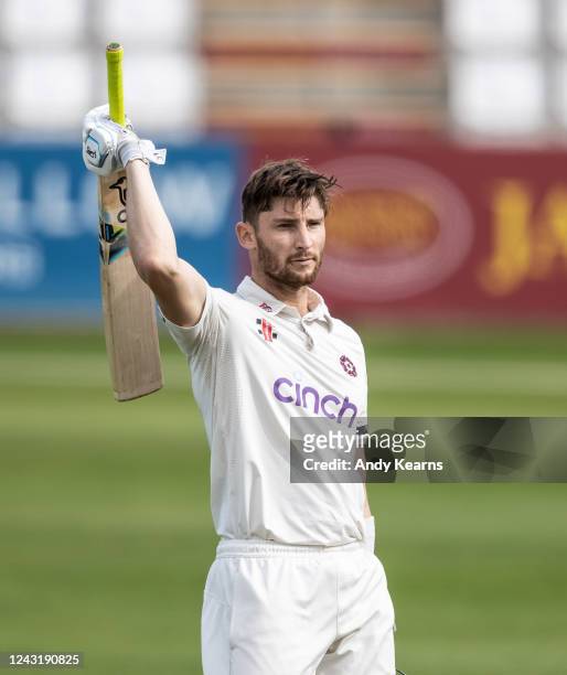 Rob Keogh of Northamptonshire acknowledges the applause on reaching his century during the LV= Insurance County Championship match between...