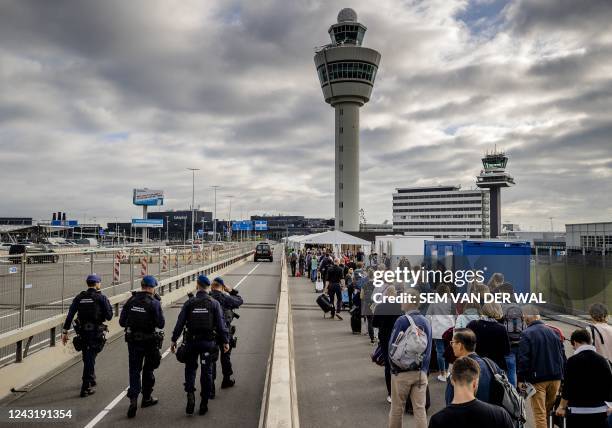 Travelers queue outside Schiphol airport, on September 13 after Schiphol Airport asked a number of airlines to cancel flights due to a shortage of...