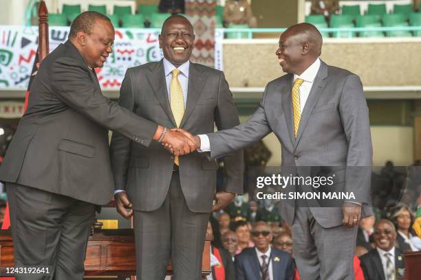 Kenya President William Ruto stands as Kenya Deputy President Rigathi Gachagua and former president Uhuru Kenyatta shake hands at the Moi...