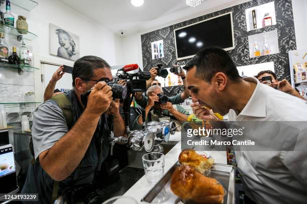 The political leader of the Civic Engagement, Luigi Di Maio, eats a baba in a bar, during the electoral tour in Naples, in the Sanità district, for...