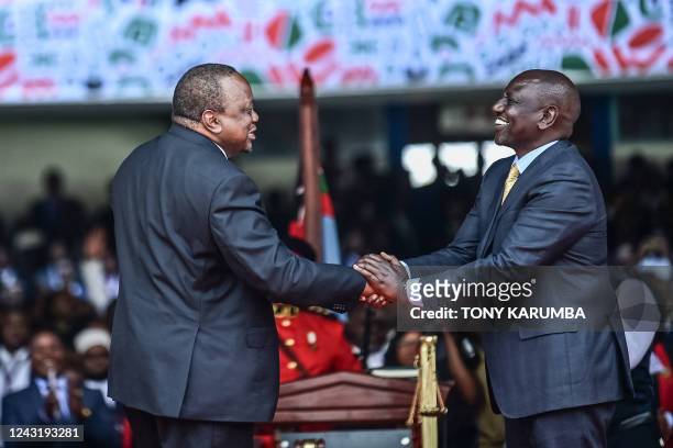 Outgoing Kenya President Uhuru Kenyatta shake hands with President William Ruto at the Moi International Sports Center Kasarani in Nairobi, Kenya, on...