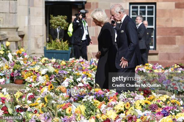 His Majesty King Charles III accompanied by Camilla, Queen Consort inspects the floral tributes left for his late mother Her Majesty Queen Elizabeth...