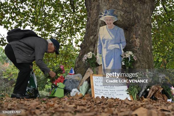 Well-wisher leaves a bunch of flowers with other floral tributes in Green Park in London on September 13 following the death of Queen Elizabeth II on...