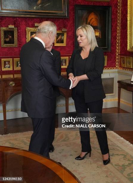 Britain's King Charles III shakes hands with Northern Ireland's Deputy First Minister and Irish republican Sinn Fein party Northern Leader Michelle...