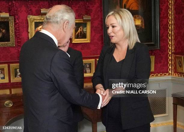 Britain's King Charles III shakes hands with Northern Ireland's Deputy First Minister and Irish republican Sinn Fein party Northern Leader Michelle...