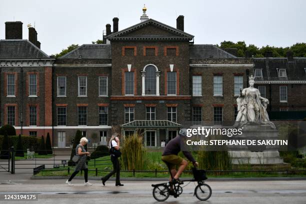 Cyclist rides past the Statue of Queen Victoria in the gardens of Kensington Palace in London on September 13 her birth place and home, it is the...