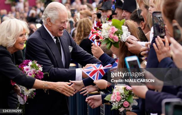 Britain's King Charles III and Britain's Camilla, Queen Consort greet wellwishers as they arrive at Hillsborough Castle in Belfast on September 13...
