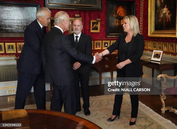 Britain's King Charles III is introduced to Speaker of the Northern Ireland Assembly, and member of the Irish republican Sinn Fein party member, Alex...