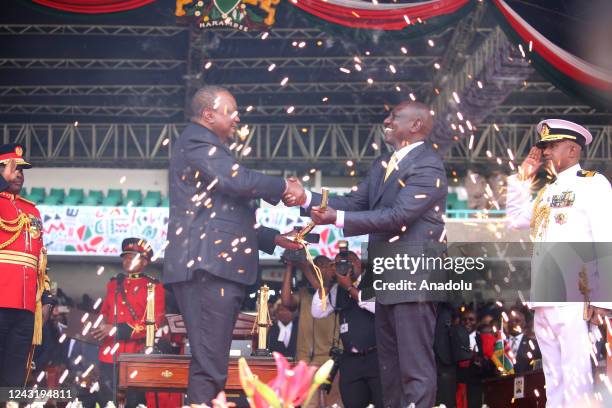 Outgoing President Uhuru Kenyatta , shakes hands with Kenya's newly elected President William Ruto during his inauguration ceremony in Nairobi, Kenya...