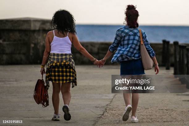 Couple walk along the Malecon in Havana, on September 13, 2022.