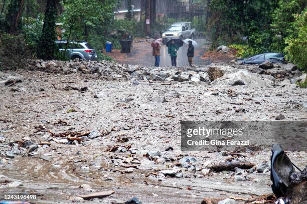 Residents are stranded on the other side of a 50 yard mudslide on Canyon Drive after heavy rains sent debris down the San Bernardino National Forest...