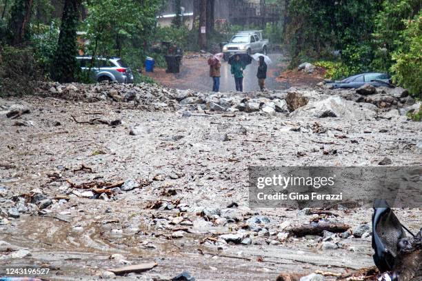 Residents are stranded on the other side of a 50 yard mudslide on Canyon Drive after heavy rains sent debris down the San Bernardino National Forest...