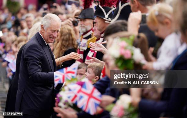 Britain's King Charles III meets members of the public during a walkabout in Writers' Square in Belfast on September 13 during his visit to Northern...