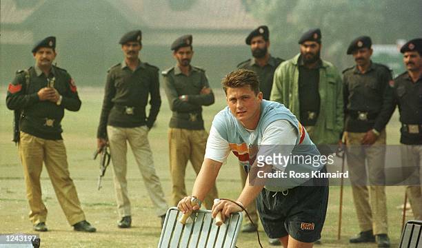Tight security surrounds Darren Gough of England during the net session at the Bagh-e-Jinnah cricket ground in Lahore. The session is part of...