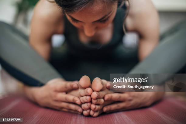 woman practice yoga at home - bikram yoga stock pictures, royalty-free photos & images