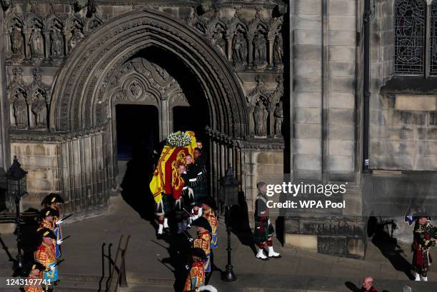 Pallbearers carry the coffin of Queen Elizabeth II from St Giles' Cathedral before it travels to Edinburgh Airport on September 13, 2022 in...