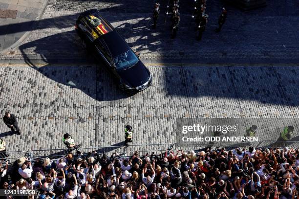 The hearse carrying the coffin of Queen Elizabeth II, leaves from from St Giles' Cathedral in Edinburgh on September 13 headed for Edinburgh airport....