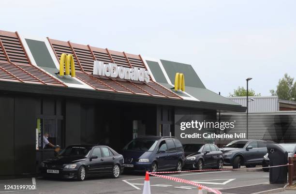 Cars queue at a drive thru McDonald's after it resumes trading on June 03, 2020 in Aylesbury, United Kingdom. The British government further relaxed...