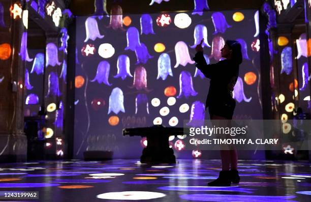 Person attends the opening press preview of Hall des Lumières, New York Citys new permanent center for immersive digital art experiences, on...